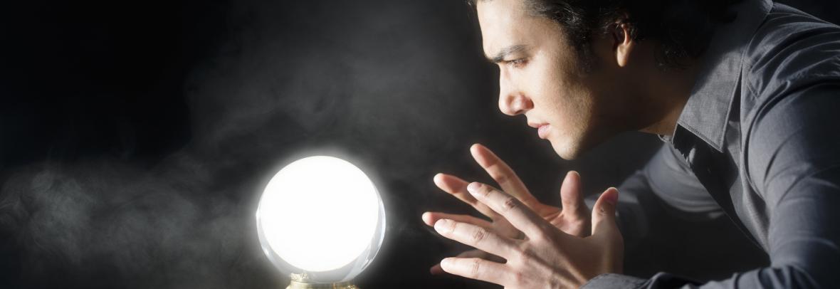 Man stares into a glowing crystal ball
