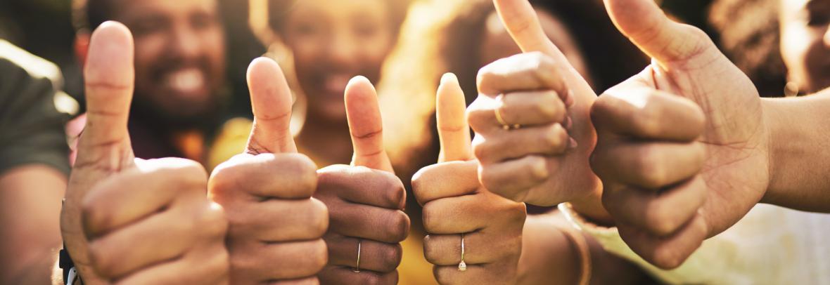 Group of people giving thumbs up sign