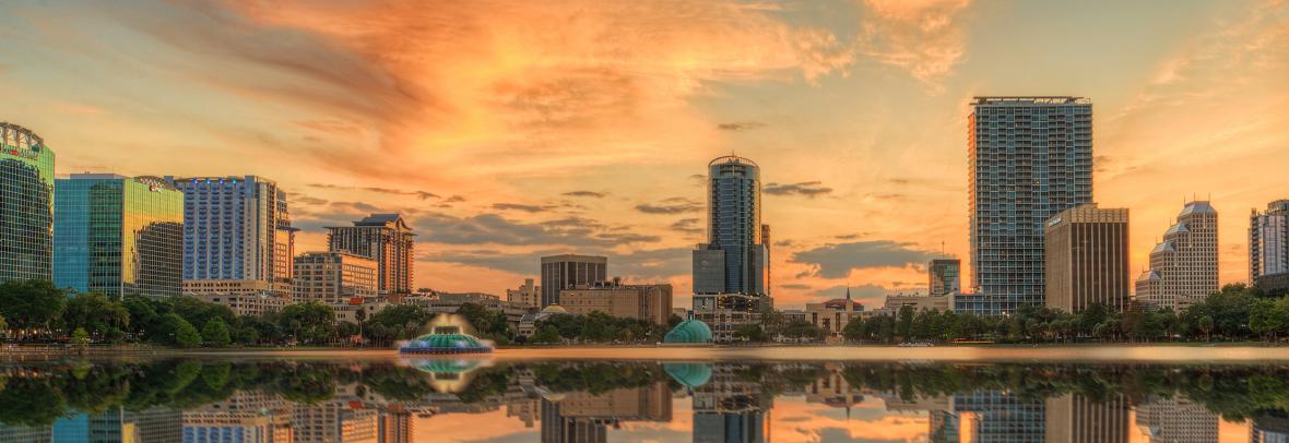 Orlando skyline at sunset with Lake Eola in the foreground