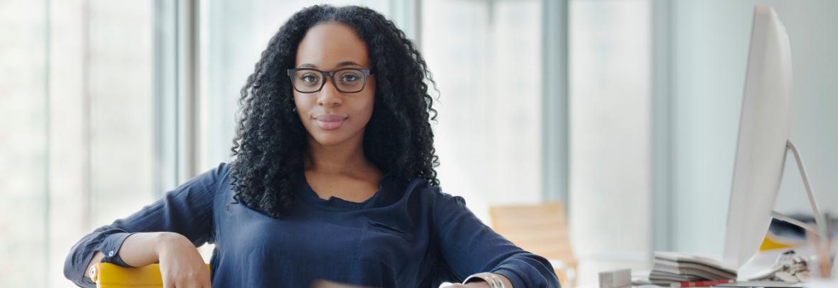 Portrait of woman sitting at desk in design office