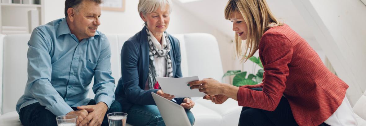 Realtor Holding contract in her hands and explaining to clients.