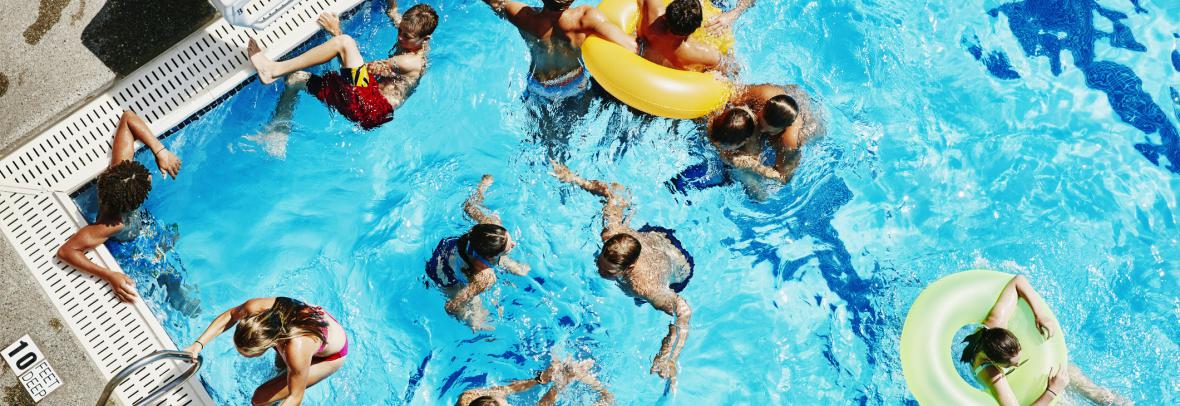 Partial picture of a swimming pool with lots of people in it