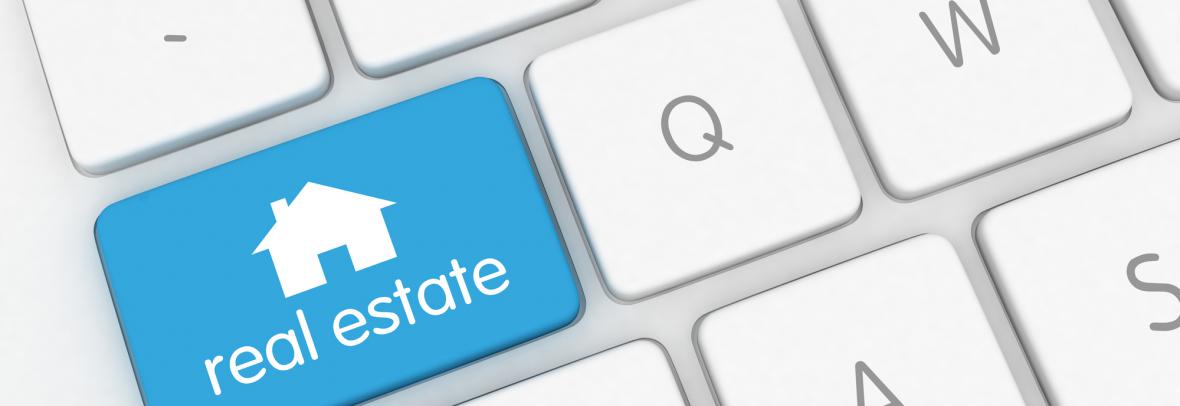 Computer keyboard with a blue real estate key