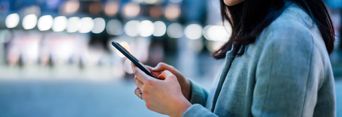 woman looking at cell phone
