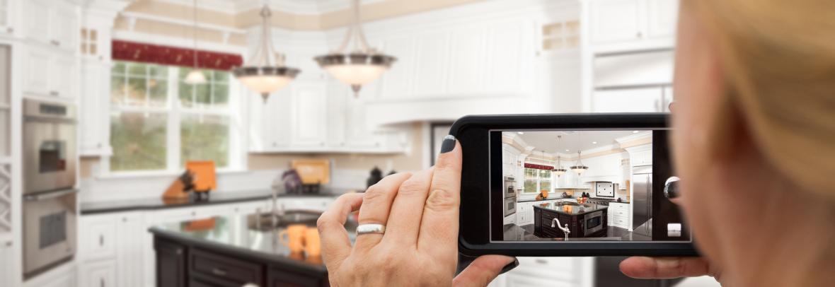 woman with camera in kitchen