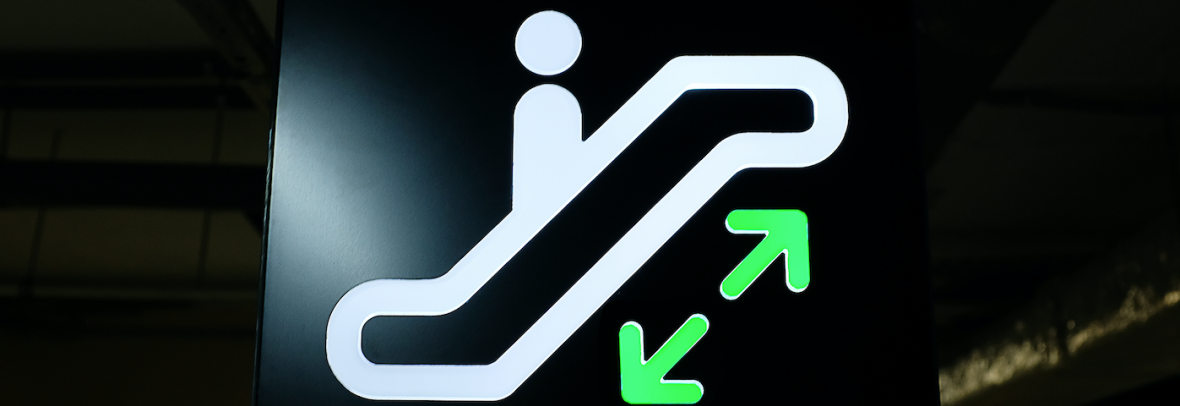 Image of a stick figure on an escalator