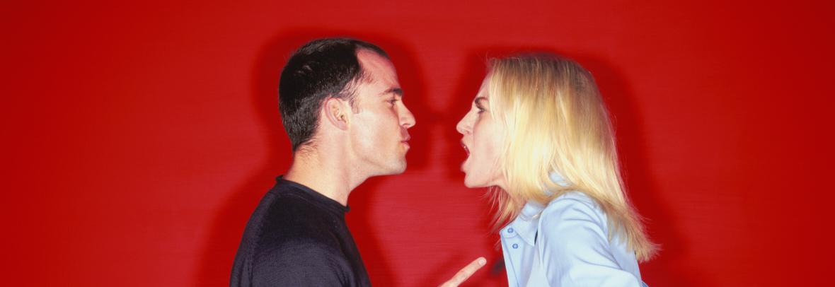A young couple arguing with the man pointing his finger