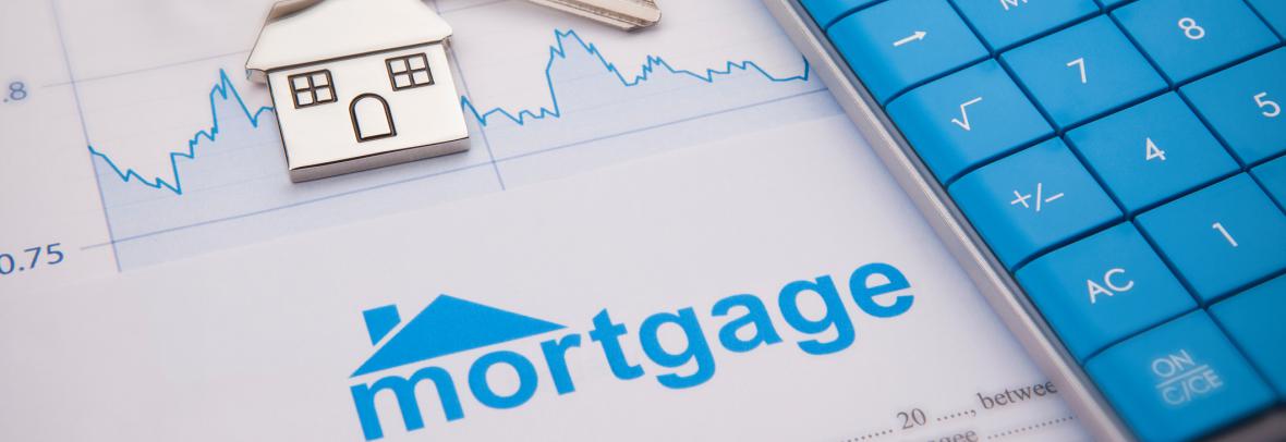 calculator with key on keyring with house on paperwork that says mortgage