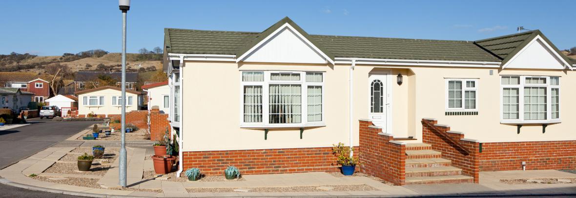 Upscale manufactured home with streetlight and brick entranceway