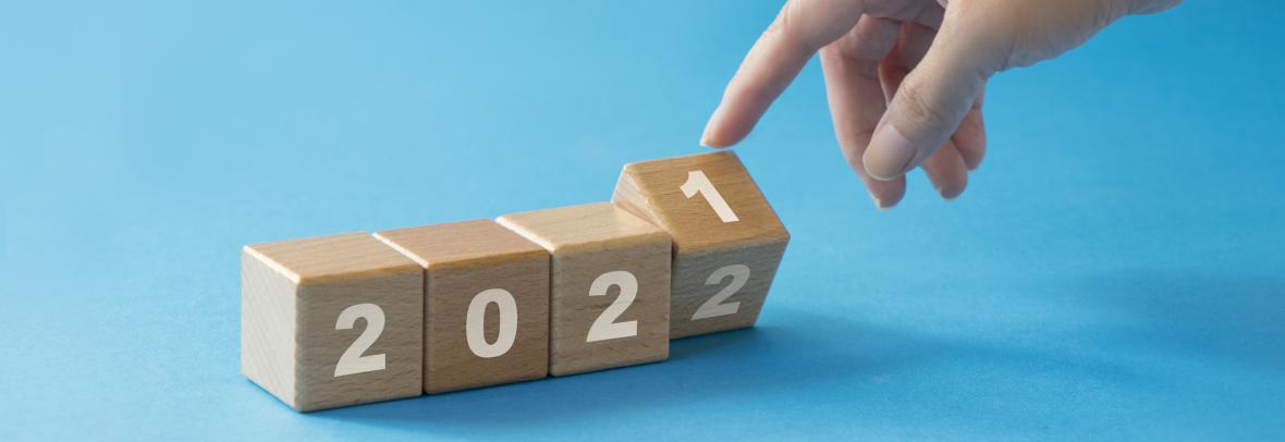 Finger turning a set of four blocks from 2021 to 2022