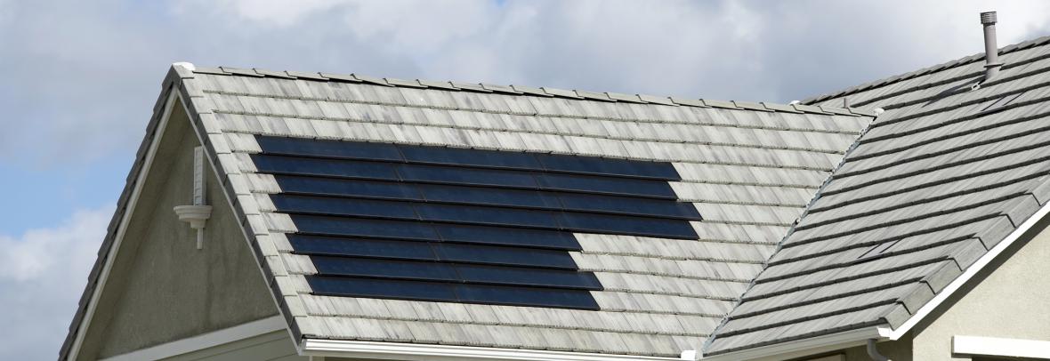 Roof with both solar shingles and regular shingles