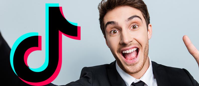 Photo of a business man make a selfie video with the TikTok logo 