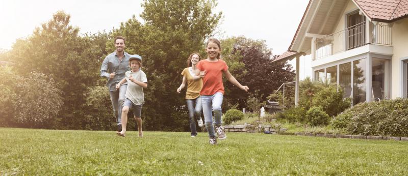Parents and kids running in yard