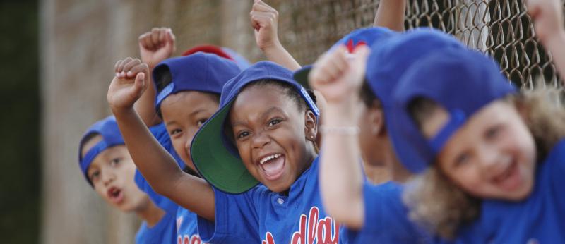 Youth baseball players cheering