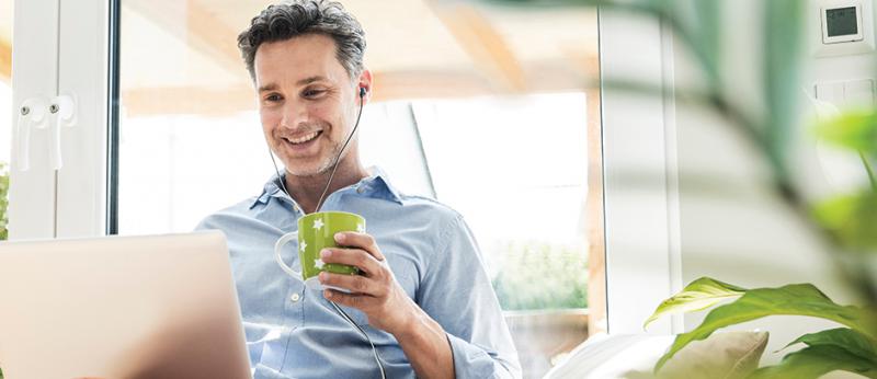 Man with headphones on listening to a podcast