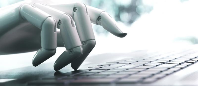 Robotic hands typing on a computer keyboard