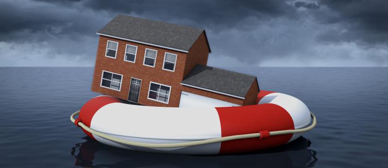 House sits inside a large life preserver floating in the ocean