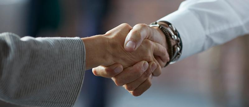 Photo of two business people shaking hands