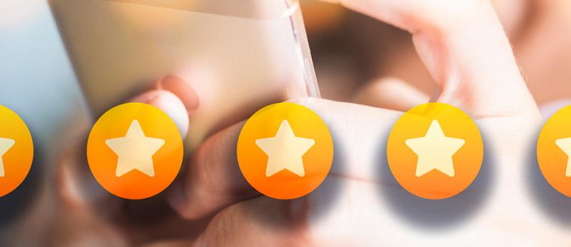 Photo of a person clicking 5 stars on her phone