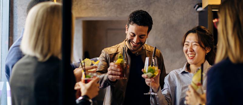 A group of business colleagues celebrating at happy hour
