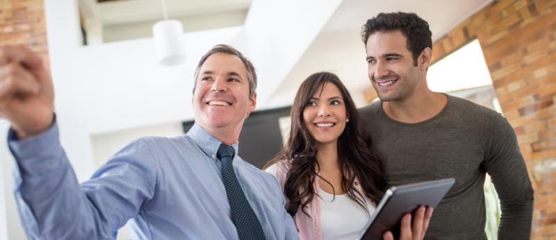 Realtor showing a couple a home