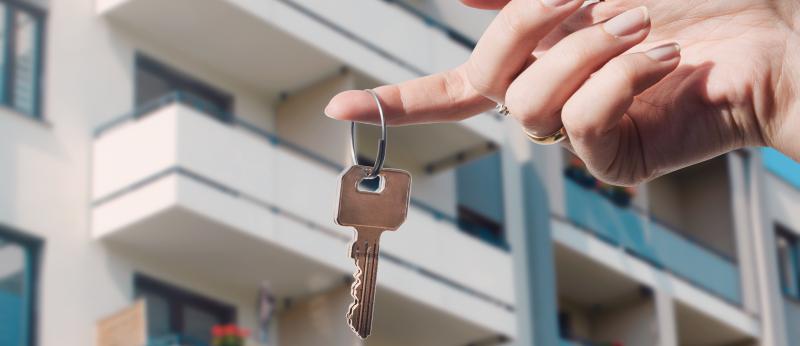  Real estate agent holding keys to new condo