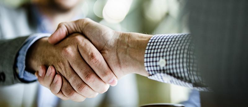 close up photo of two business men shaking hands