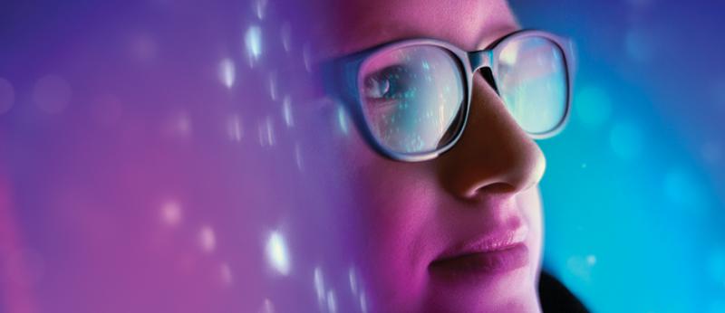 photo of a woman looking into cyberspace blue background