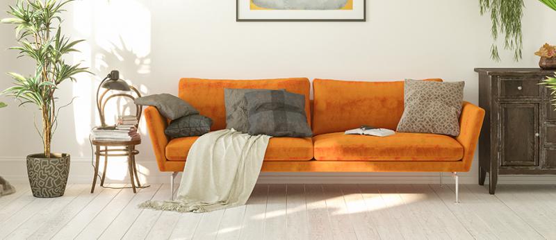 Photo of a living room with a modern orange couch and other modern decor