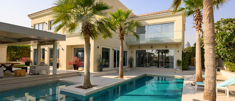 Luxury villa with palm trees and swimming pool. Exterior of modern house. Empty back area of house