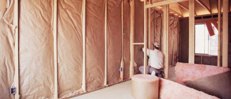 Installing insulation into wall of new home