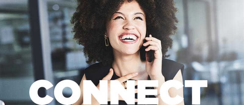 Photo of a woman with a big smile while talking on the phone