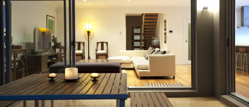 Indoor-outdoor living space with couch in living room and table on patio