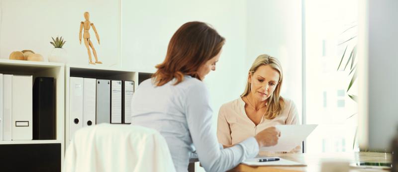 women looking at paperwork filling out forms