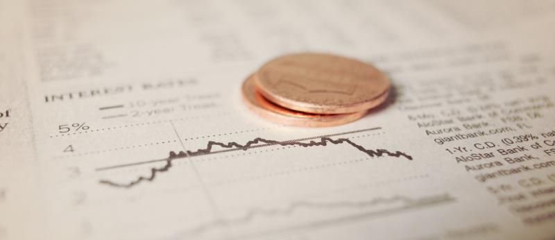 newspaper with coins interest rates