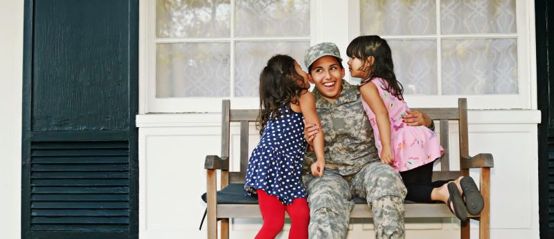 veteran family on bench on porch
