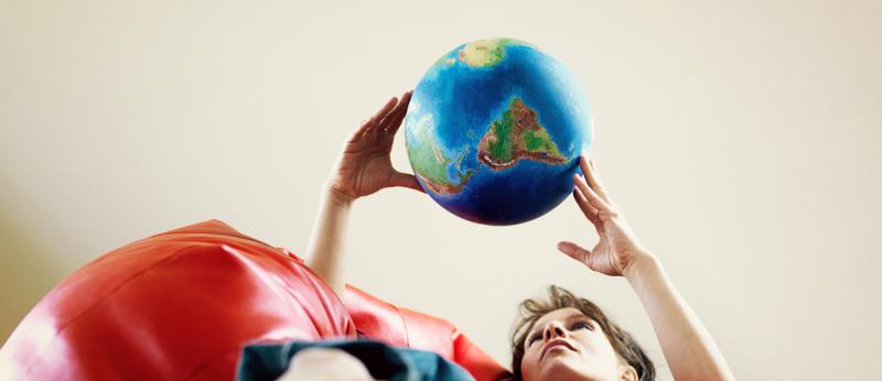 woman holding a globe