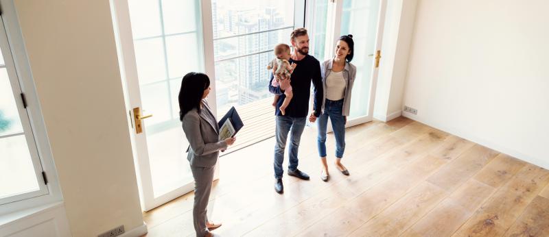 realtor shows a family a house