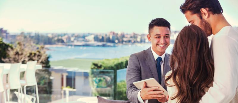 realtor and clients looking at luxury real estate