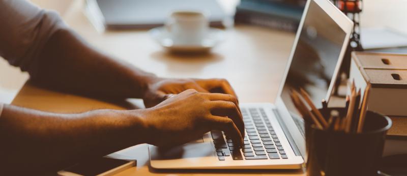man typing on a computer