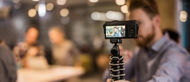 Close up of redhead man making reportage by vlogging.