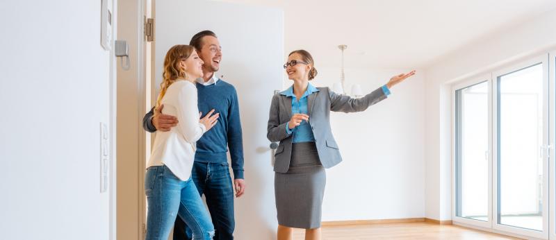 realtor showing a home to a couple