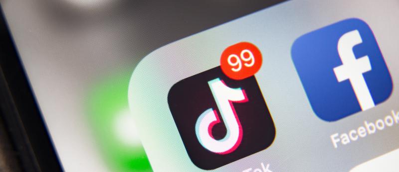 Smart phone screen with icons for TikTok, Facebook and Twitter