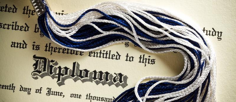 Graduation diploma with tassel across it