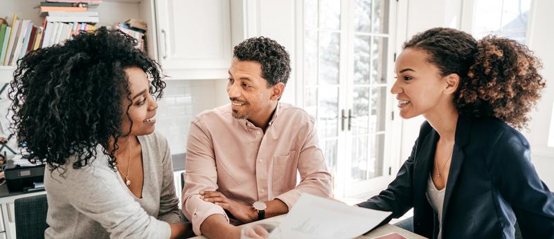 Photo of helpful real estate agent with clients