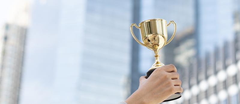 Photo of a person holding a trophy