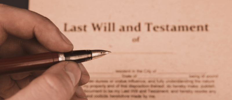 Photo of someone signing a Last Will and Testament