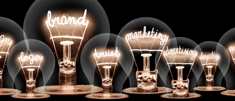 Photo illustration of lightbulbs with the words, brand, design, logo, marketing etc inside the bulbs