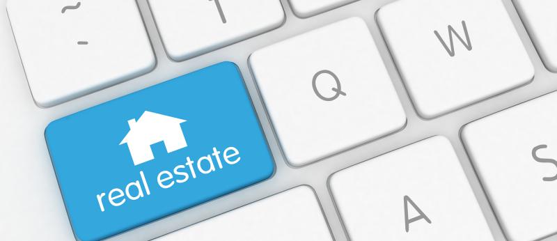 Computer keyboard with a blue real estate key