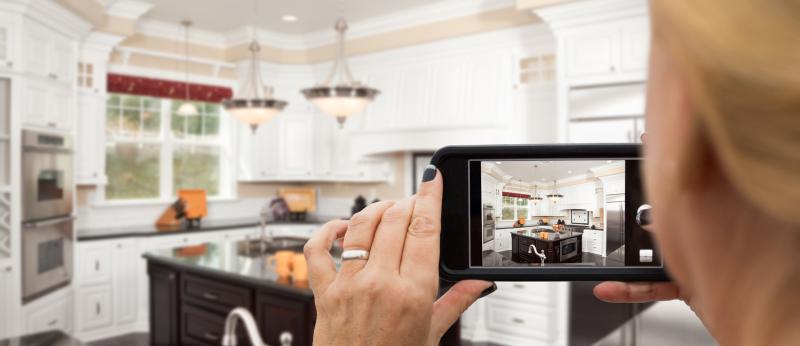woman with camera in kitchen